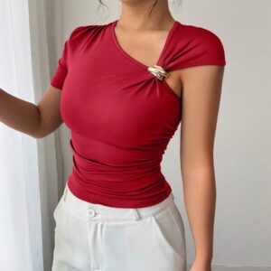 Elenzga Top à manches courtes pour femmes avec encolure asymétrique élégante, décoré de boutons en métal or rose 3D